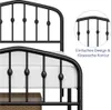 Close-up of a black metal bed frame with a mattress, showing decorative elements and a detail view with text. Podgląd zdjęcia produktu