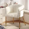 A fluffy white chair with gold legs is placed in a room with a vanity and a window seat. Anteprima dell’immagine prodotto