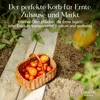 A woven basket filled with tomatoes and other produce sits on a path in a garden. Produktbild-Vorschau