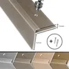 A close-up of a bronze-colored stair nosing profile, showing a drill creating a hole for installation, with dimensions and included hardware indicated. Podgląd zdjęcia produktu