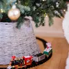 A toy train set circling a Christmas tree. Podgląd zdjęcia produktu