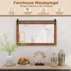 A farmhouse-style wall mirror with a wooden frame, displayed above a console table with decorative items. Podgląd zdjęcia produktu