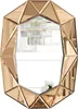 A decorative mirror with a faceted frame, reflecting a chandelier and flowers. Produktbild-Vorschau