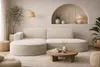 A modern living room scene featuring a sectional sofa. Produktbild-Vorschau