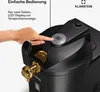 A hand is shown pressing a button on a black and gold beer dispenser with a digital display. Produktbild-Vorschau