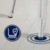 Close-up of the base of a silver metal bar stool leg on a light wooden floor, with a circular graphic indicating stability or protection. Náhľad obrázku produktu