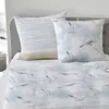 A neatly made bed with bedding featuring a seagull print. Produktbild-Vorschau