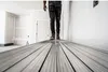 A person is walking on a construction site, on a plank. Produktbild-Vorschau