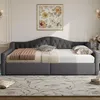 A gray upholstered daybed with a tufted headboard is shown in a well-lit room with a floral rug and artwork on the wall. Náhľad obrázku produktu