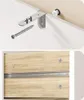 Close-up view of furniture assembly hardware and drawer slides. Podgląd zdjęcia produktu
