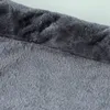 A close-up view of a dark gray plush fabric, showing the texture and weave. Produktbild-Vorschau