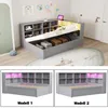 A grey hydraulic daybed with storage, shelves, and LED lighting, shown in a room setting and in two different model views. Anteprima dell’immagine prodotto