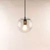 A clear shot of a glass pendant light with a visible bulb. Produktbild-Vorschau