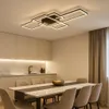 A modern dining room with a sleek ceiling light fixture above a table. Produktbild-Vorschau