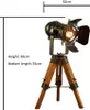 A vintage-style desk lamp with a wooden tripod base and an adjustable spotlight head. Náhled obrázku produktu