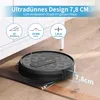A black robot vacuum cleaner is shown on a wooden floor near a white cabinet. The image highlights its slim design and climbing ability. Produktbild-Vorschau