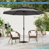An outdoor patio scene with a large gray umbrella, two wicker chairs with white cushions, and a small side table. Náhled obrázku produktu