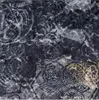 A close-up of a dark fabric with a repeating pattern of intricate Celtic knotwork and floral motifs in white and gold. Náhľad obrázku produktu
