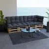 A pallet sofa with cushions on a balcony overlooking the ocean. Voir les images du produit