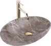 A marble sink with a gold faucet. Anteprima dell’immagine prodotto