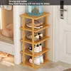A multi-tiered bamboo shoe rack with shoes on each shelf, placed next to a doorway. Produktbild-Vorschau