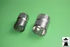 Two metal pipe connectors are placed on a green background. Produktbild-Vorschau