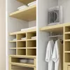A closet with shelves and hanging clothes, featuring a small white heater on a shelf. Anteprima dell’immagine prodotto