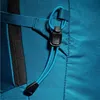 A close-up view of a teal backpack's zipper and a blue drawstring with a black toggle. Náhled obrázku produktu