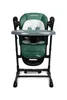 A green baby high chair with a white insert and gray tray, shown from the front on a white background. Produktbild-Vorschau