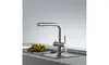 A modern kitchen sink with a stainless steel faucet and a bowl of yellow fruit. Anteprima dell’immagine prodotto