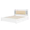 A white bed frame with a beige upholstered headboard and built-in shelving, shown against a white background. Náhled obrázku produktu