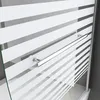 A close-up view of a shower screen with frosted horizontal stripes and a chrome handle. Produktbild-Vorschau