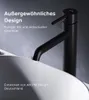 A black faucet is shown in close-up, mounted on a white sink, with descriptive text overlayed. Produktbild-Vorschau
