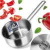 A stainless steel pot with chopped red bell peppers and basil leaves scattered around it. Produktbild-Vorschau