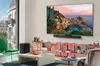 A modern living room with a large TV displaying a scenic view, a soundbar, and various decorative items on shelves. Produktbild-Vorschau