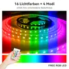 A hand holding a remote control in front of a coiled LED light strip displaying multiple colors. Anteprima dell’immagine prodotto