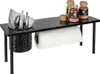 A black metal shelf unit designed for kitchen use, holding cutlery, napkins, spices, and a paper towel roll. Náhled obrázku produktu