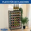 A metal wine rack filled with wine bottles, with plants and a wall in the background. Anteprima dell’immagine prodotto