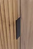 A close-up view of a wooden cabinet door with a black handle. Produktbild-Vorschau