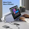 A laptop connected to a USB hub, with a portable hard drive and a small fan also connected. Produktbild-Vorschau