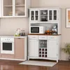 A kitchen scene featuring a white hutch with a microwave, mixer, and fruit on top, and a wine rack and cabinets below. To the left is a white oven with a pink drawer. Podgląd zdjęcia produktu