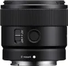 A close-up view of a black camera lens. Produktbild-Vorschau