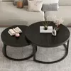 Two round coffee tables are placed on a carpet in front of a sofa. Produktbild-Vorschau