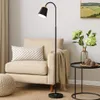A modern living room scene with a floor lamp, armchair, and side table. Náhľad obrázku produktu