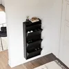 A black shoe cabinet is mounted on a white wall in a hallway, with shoes stored inside. Voir les images du produit