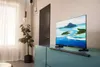A television is placed on a cabinet in a modern living room. Produktbild-Vorschau