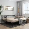 A bedroom scene with a daybed, pillows, and a blanket. Náhled obrázku produktu