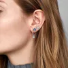 Close-up of a person's ear with multiple earrings. Produktbild-Vorschau