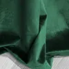 A close-up view of dark green velvet fabric, showing its texture and folds. Produktbild-Vorschau