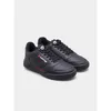 A pair of black Lotto sneakers with red accents, shown from a side angle against a light gray background. Podgląd zdjęcia produktu